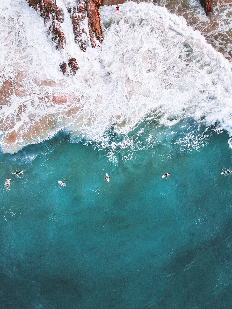 a group of people are swimming in the ocean, by Lee Loughridge, pexels, bird\'s eye view, surf, stock photo, usa-sep 20