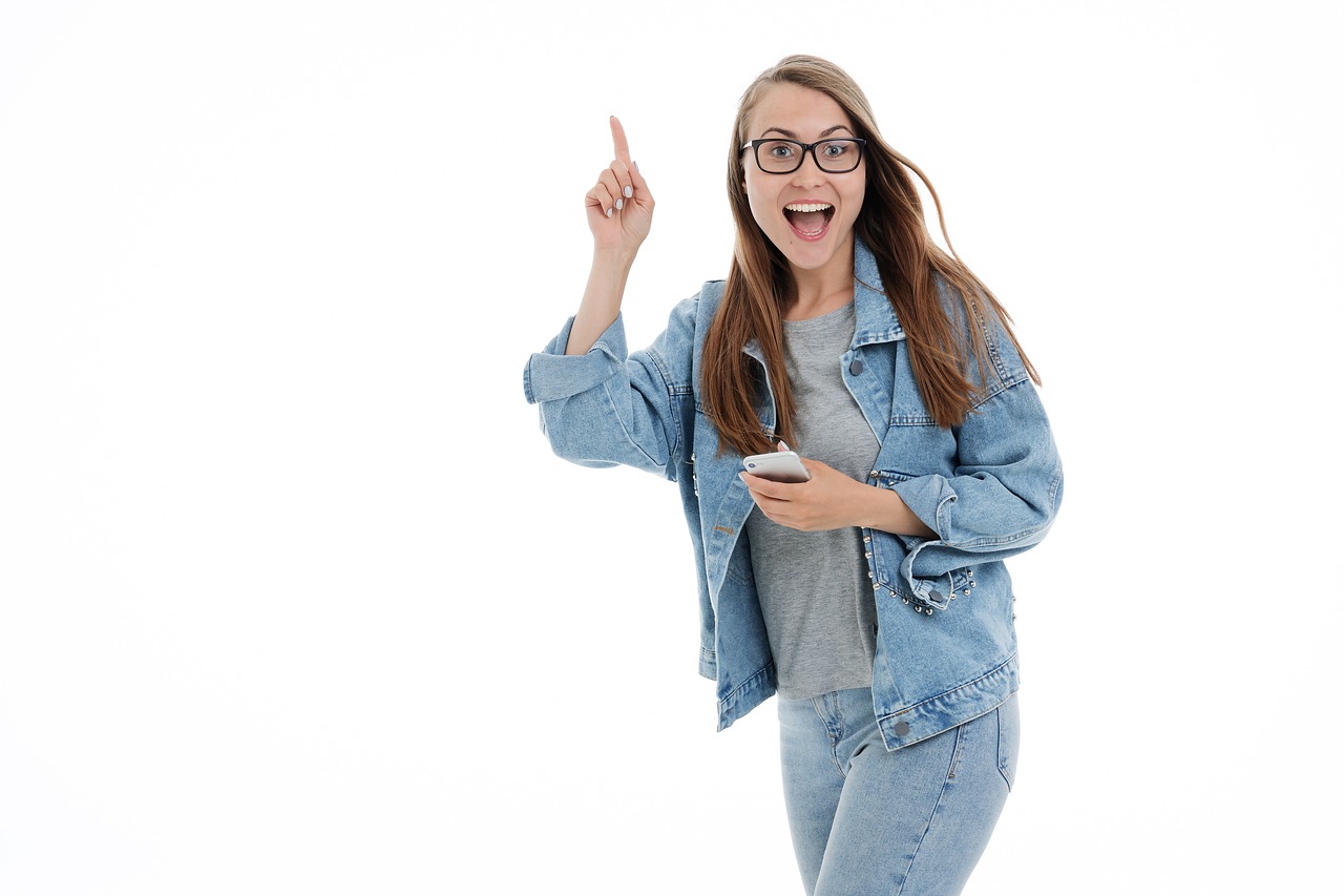 a woman in a denim jacket and glasses holding a cell phone, shutterstock, happening, isolated white background, excitement, pokimane, text and a pale young woman