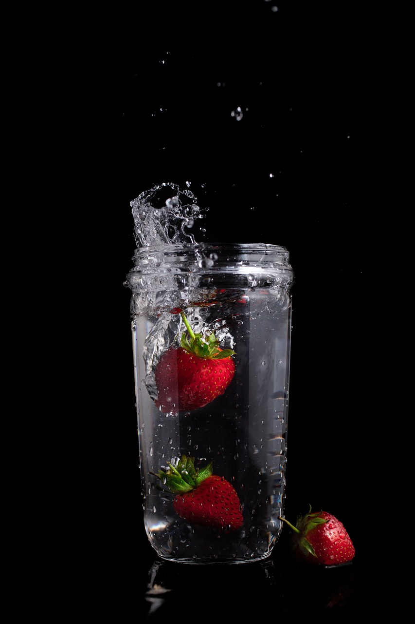two strawberries falling into a glass of water, by Ivan Grohar, glass jar, hero shot, water spray, high detail photo