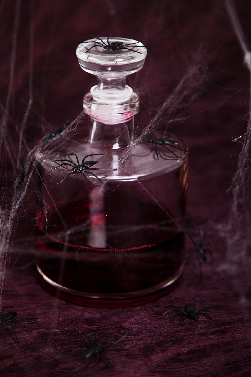 a bottle sitting on top of a table covered in spider webs, vanitas, close-up product photo, transparent liquid, some red and purple, closeup - view