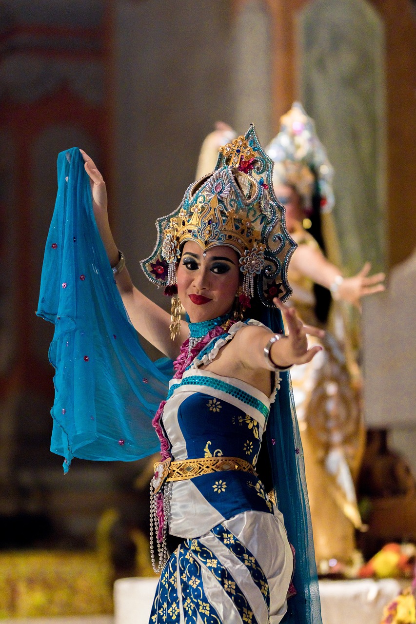 a woman in a blue dress holding a blue umbrella, flickr, sumatraism, submerged temple dance scene, wearing an ornate outfit, triumphant pose, full view with focus on subject