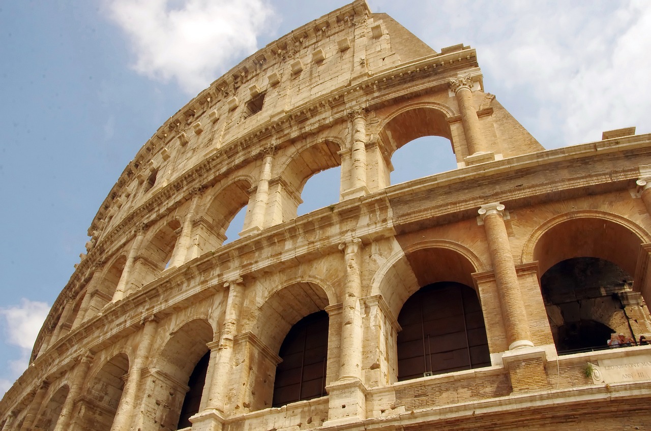 a close up of a building with a sky background, a picture, inspired by Romano Vio, coliseum backdrop, massive arch, straw, tan