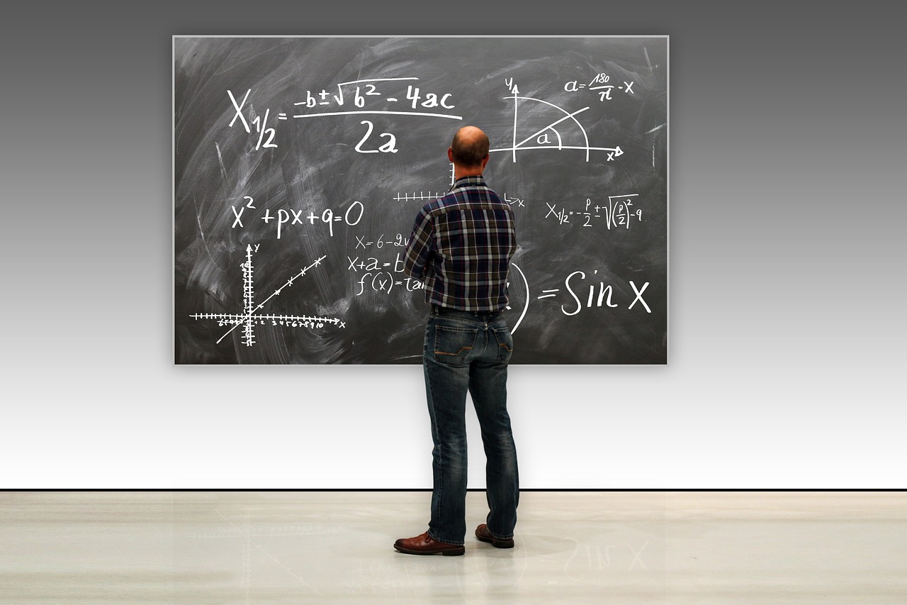 a man is standing in front of a blackboard, a photo, by Jeffrey Smith, analytical art, mathematics and geometry, help me