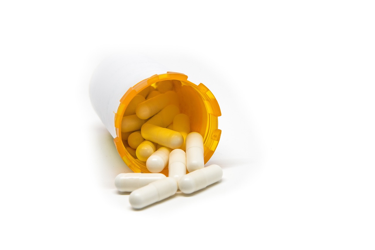 a bottle of pills sitting on top of a table, by Matt Cavotta, shutterstock, white and yellow scheme, isolated on white background, open synthetic maw, 8 0 mm photo