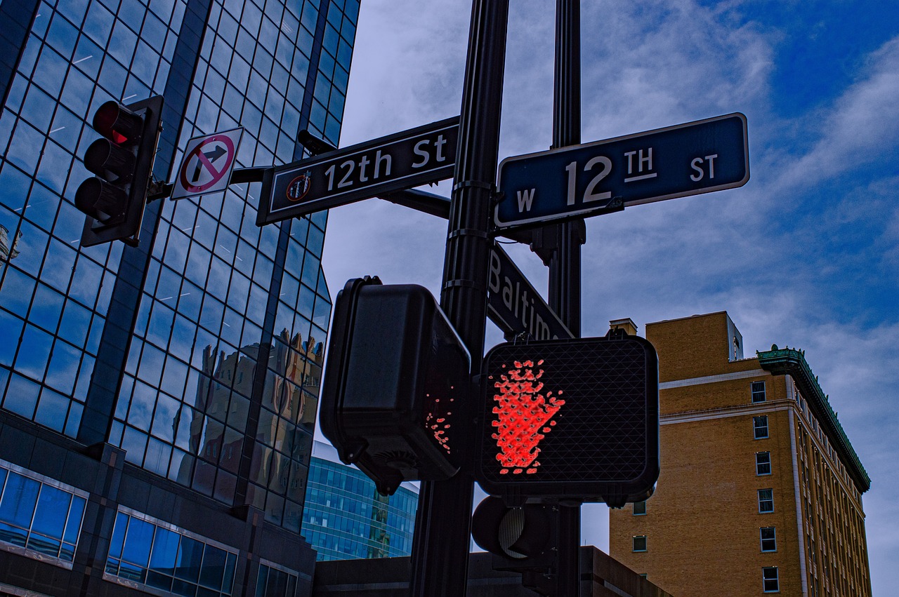 a close up of a traffic light with a building in the background, a photo, flickr, street art, red hearts, 1 2 - bit, winnipeg skyline, cyberpunk signs