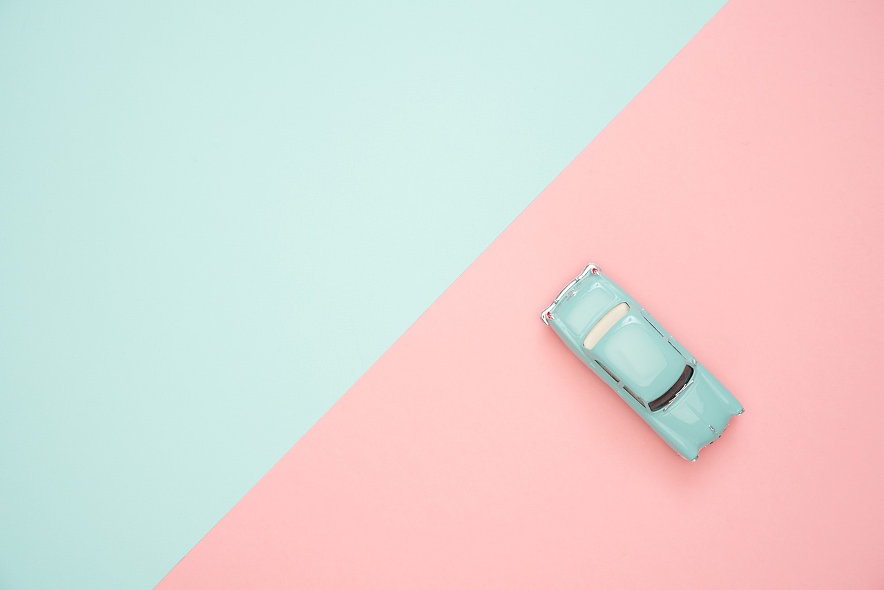 a blue car sitting on top of a pink and blue surface, a pastel, postminimalism, top - view, toy commercial photo, pink white turquoise, vintage car