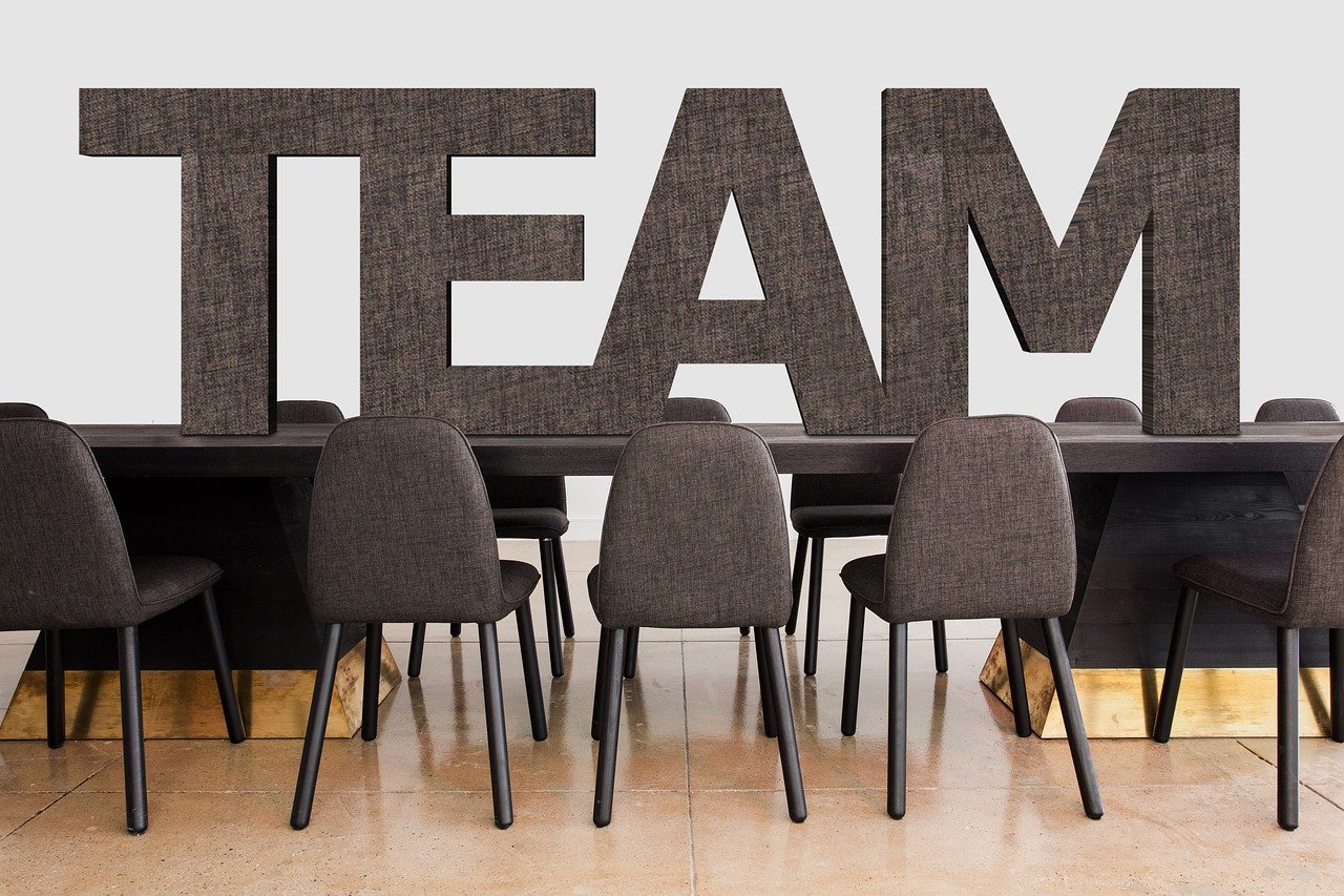 a group of chairs sitting in front of a table, by Juan O'Gorman, lettering clean, teams, beam, peter hurley