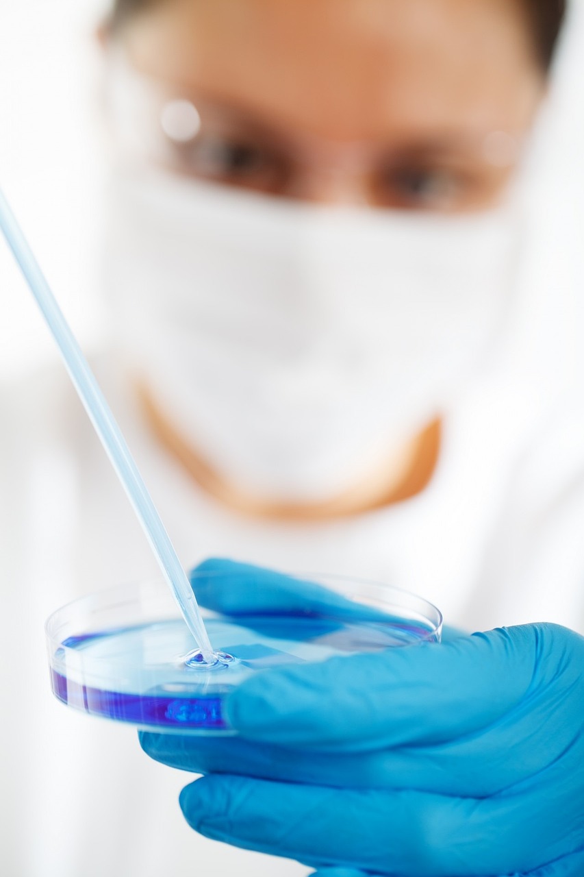 a close up of a person in a lab coat holding a petrifying device, shutterstock, plasticien, dissolution filter, blue, wearing gloves, in profile