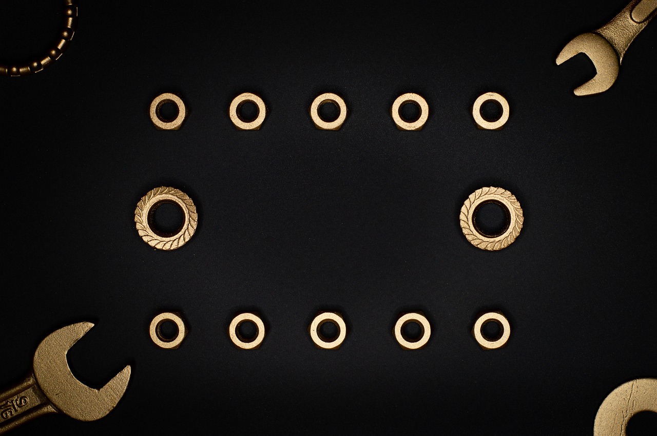 a group of tools sitting on top of a table, by Ottó Baditz, unsplash, baroque, gold gilded circle halo, on black background, many holes, high detail product photo