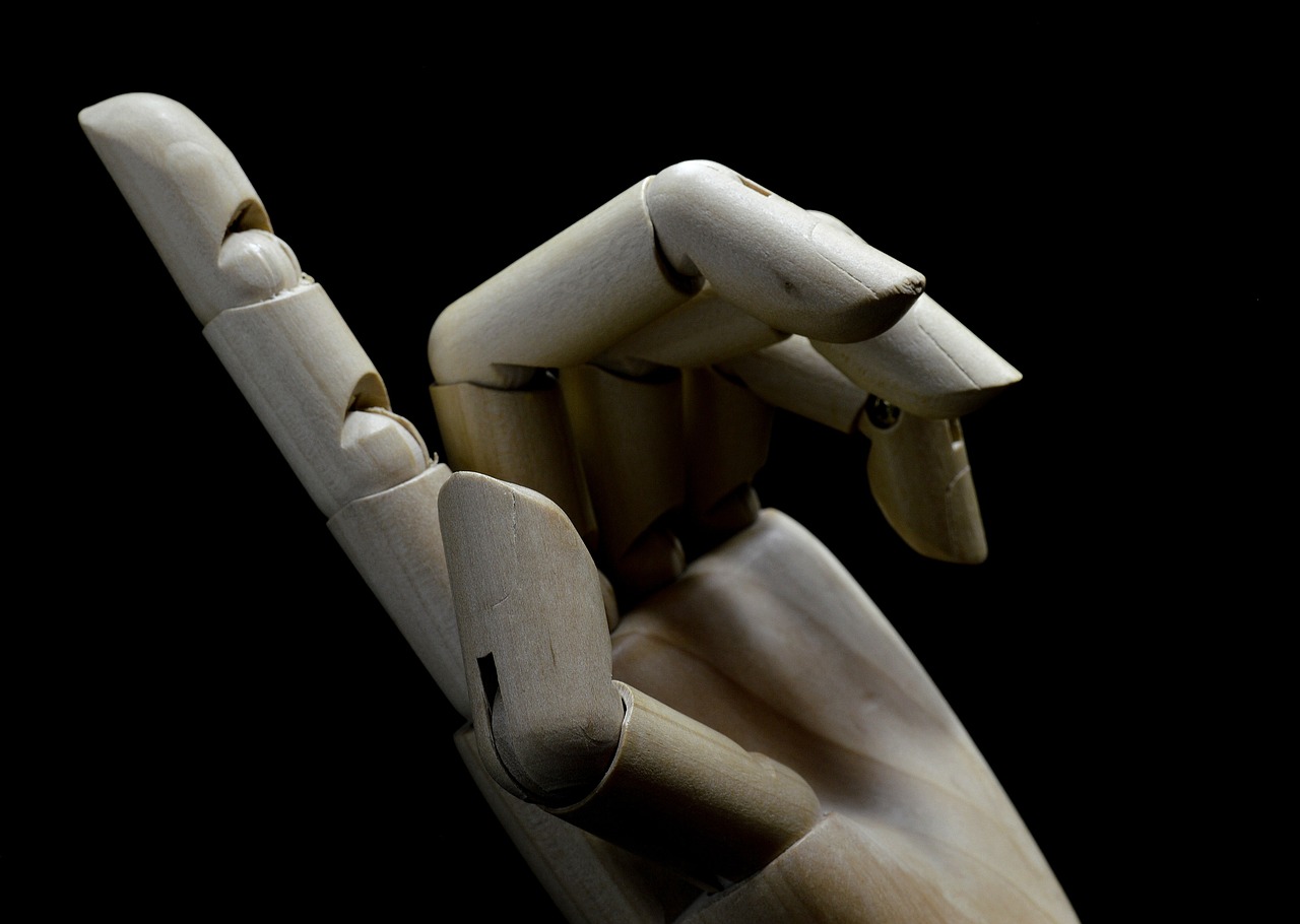 a wooden hand making a peace sign with it's fingers, an abstract sculpture, by Julian Allen, pexels, visual art, realistic shaded robotic parts, with a black background, stock photo, doll in hand