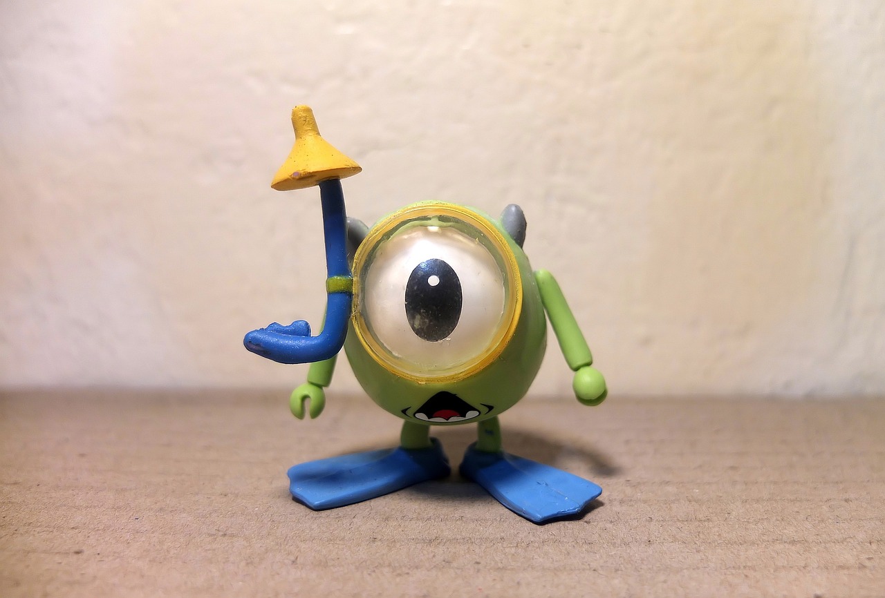 a close up of a toy on a table, a picture, inspired by Pixar, lowbrow, ((fish eye)), mike wazowski, plastic action figure, cone