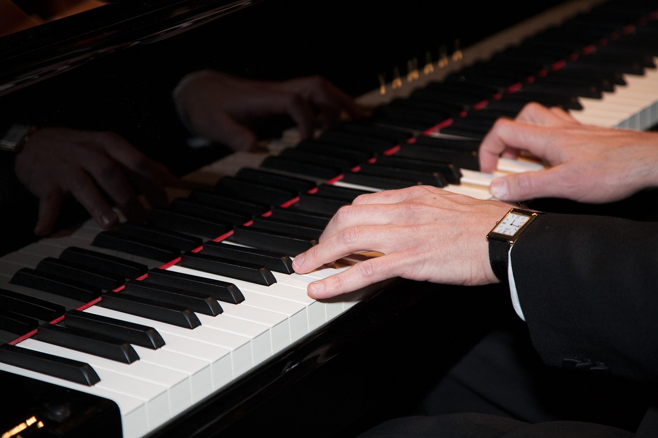 a close up of a person playing a piano, by Robert Medley, wearing presidential band, very sharp photo