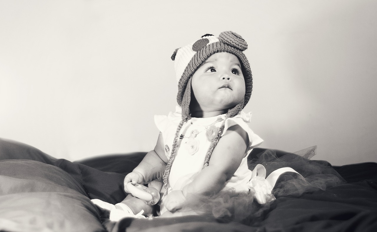 a black and white photo of a baby wearing a hat, a black and white photo, by Basuki Abdullah, art photography, retro effect, studio shooting, 8 k photo, of an beautiful angel girl