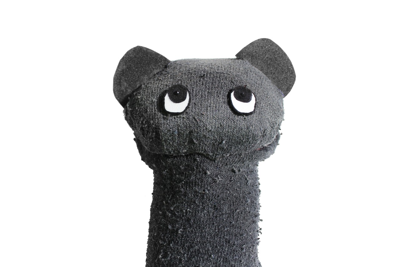 a close up of a stuffed animal on a white background, dada, made of smooth black goo, scratching post, claymation character, product introduction photo