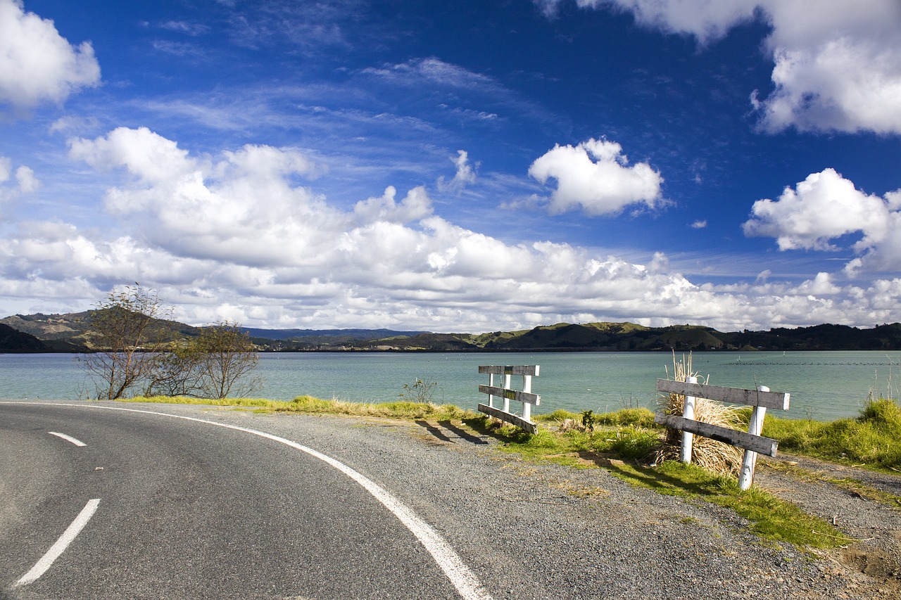 a curved road next to a body of water, by James Ardern Grant, flickr, hurufiyya, wide shot!!!!!!, bay, landscape photo-imagery, heaven on earth