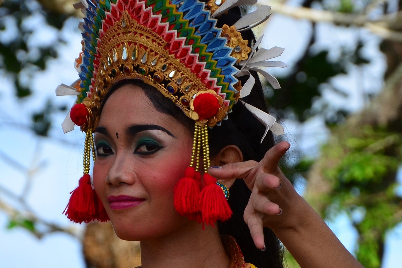 a close up of a person wearing a headdress, inspired by I Ketut Soki, pexels contest winner, she is dancing, handsome girl, polinesian style, dlsr photo