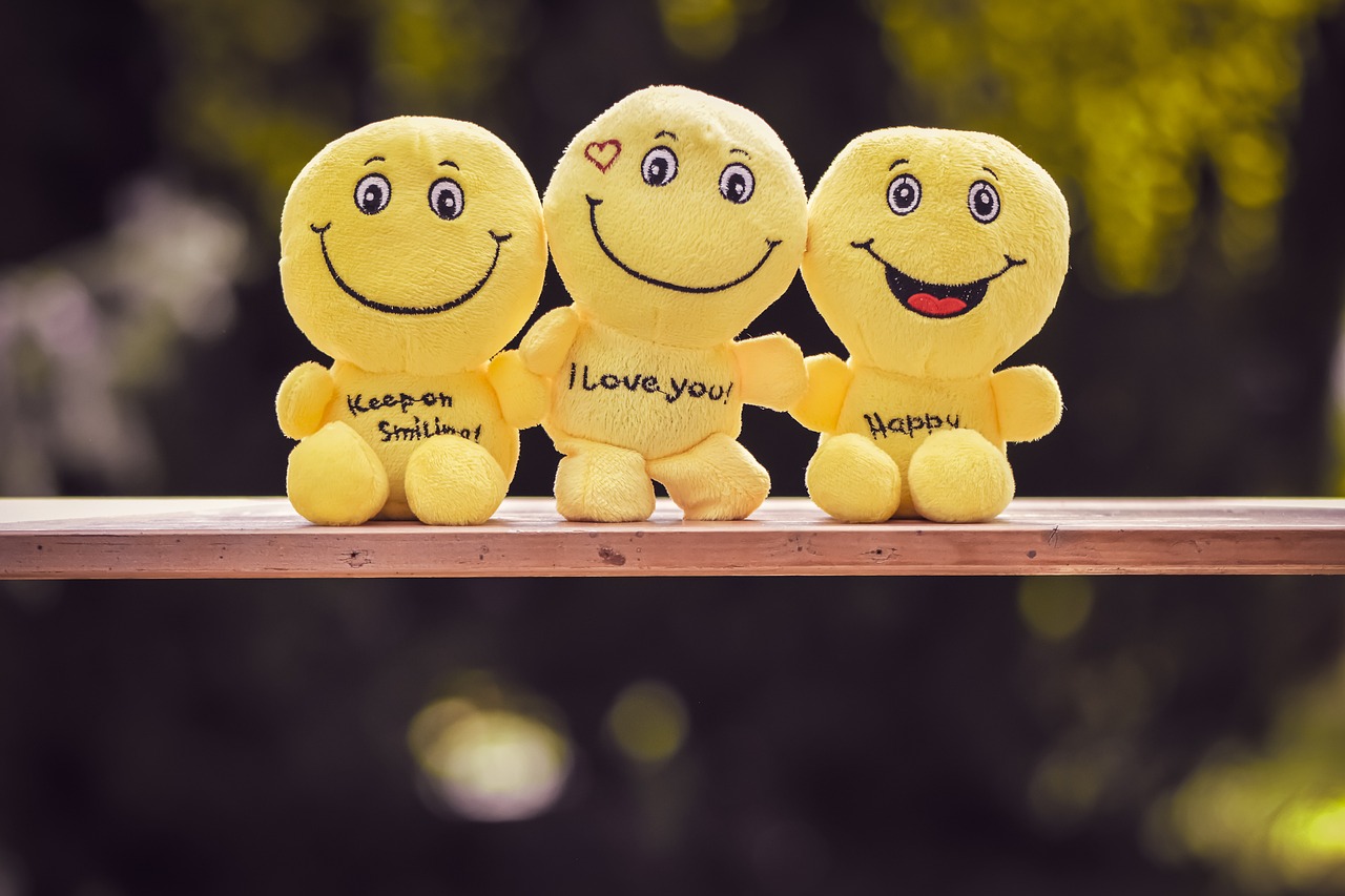 three yellow smiley faces sitting on top of a wooden bench, a picture, inspired by Ke Jiusi, pexels, plush doll, happy birthday, cute woman, i love you