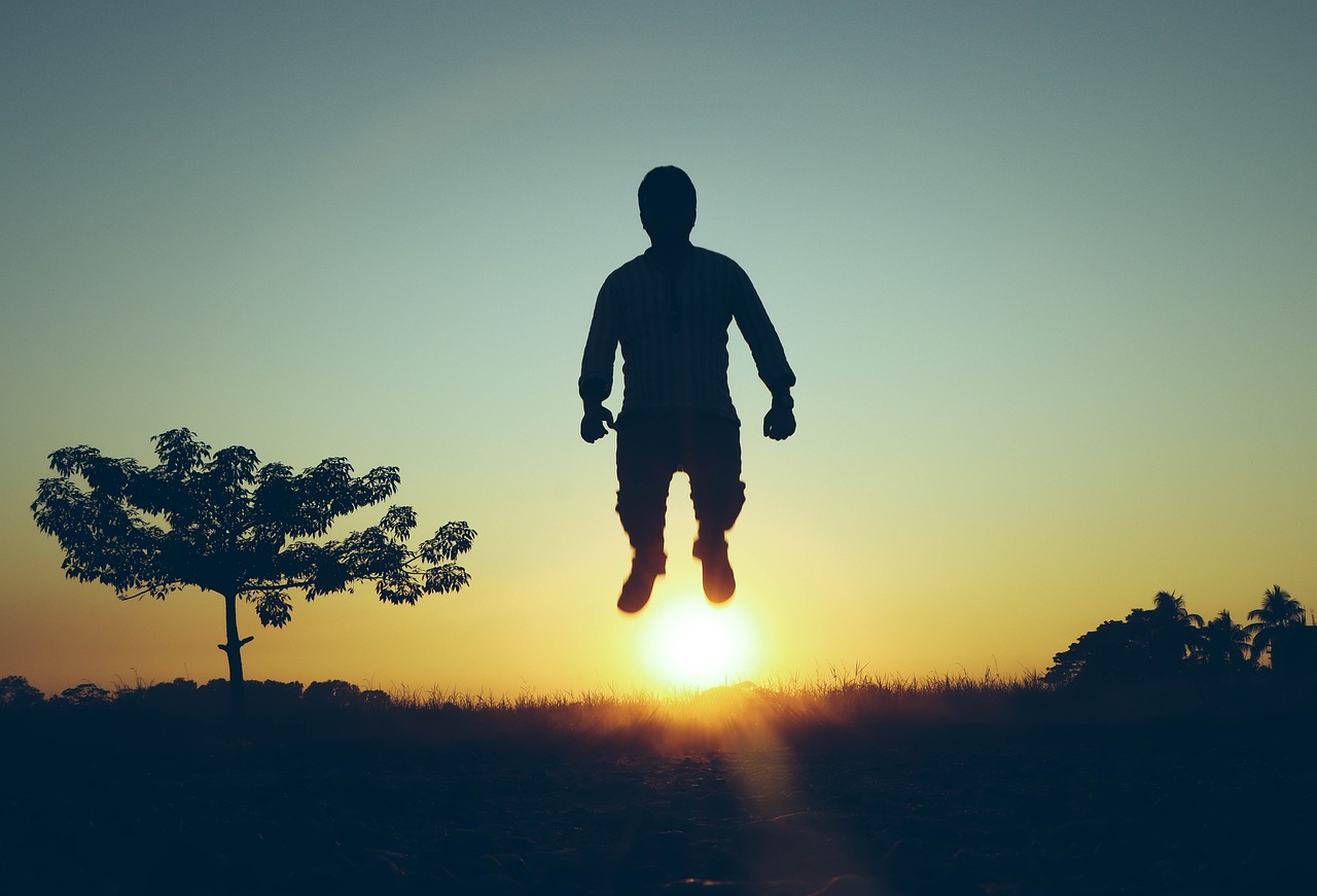 a silhouette of a person jumping in the air, a picture, inspired by Kim Hwan-gi, figuration libre, adventure hyper realistic render, retro effect, in flight suit, golden hour photo