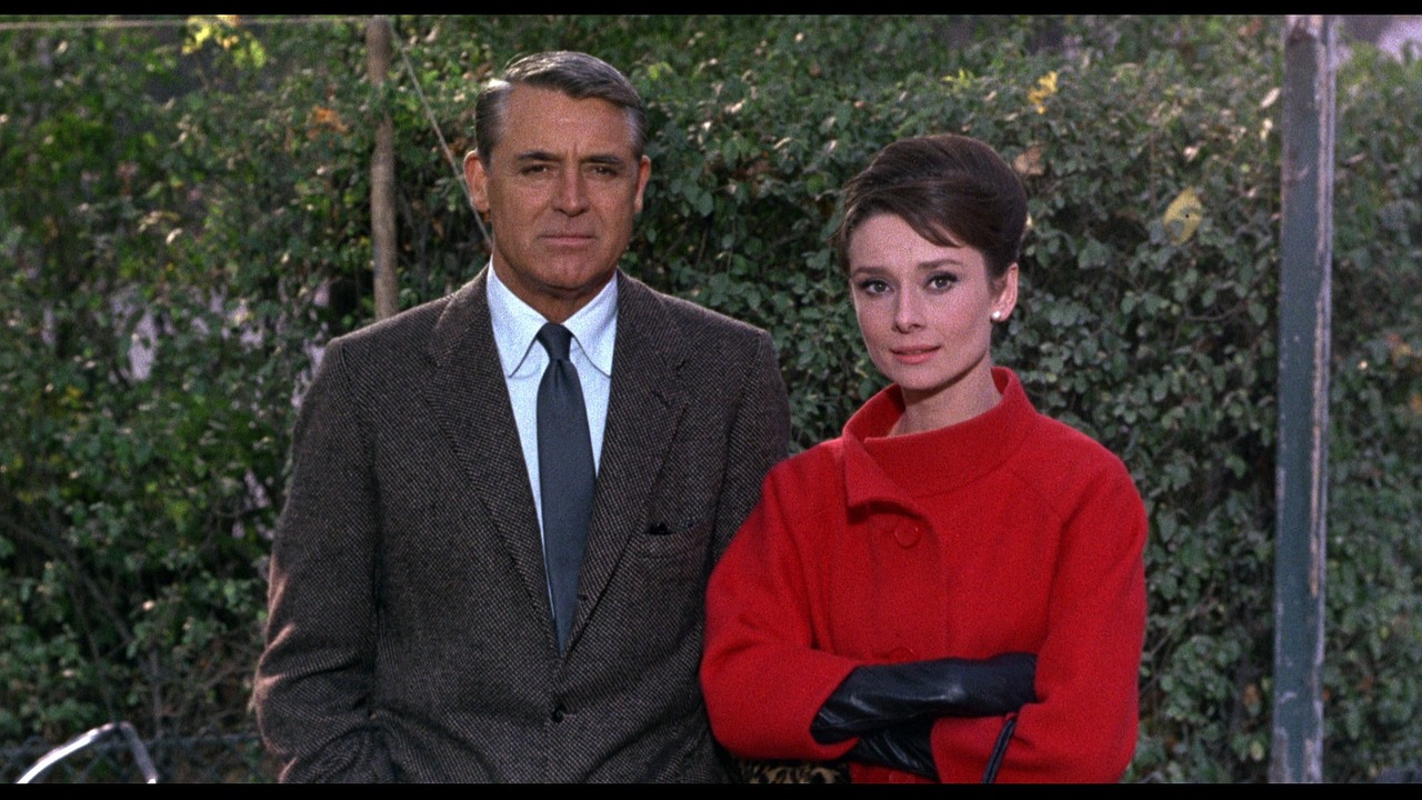 a man and a woman standing next to each other, by Harvey Pratt, flickr, audrey hepburn, in crimson red, medium shot of two characters, cone