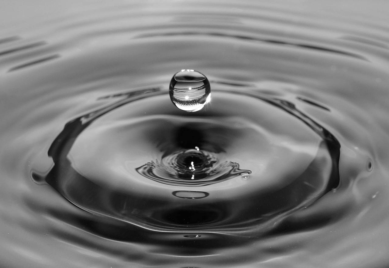 a black and white photo of a drop of water, by Jan Rustem, pexels, honey ripples, wikimedia, hyperdetailed!, istockphoto