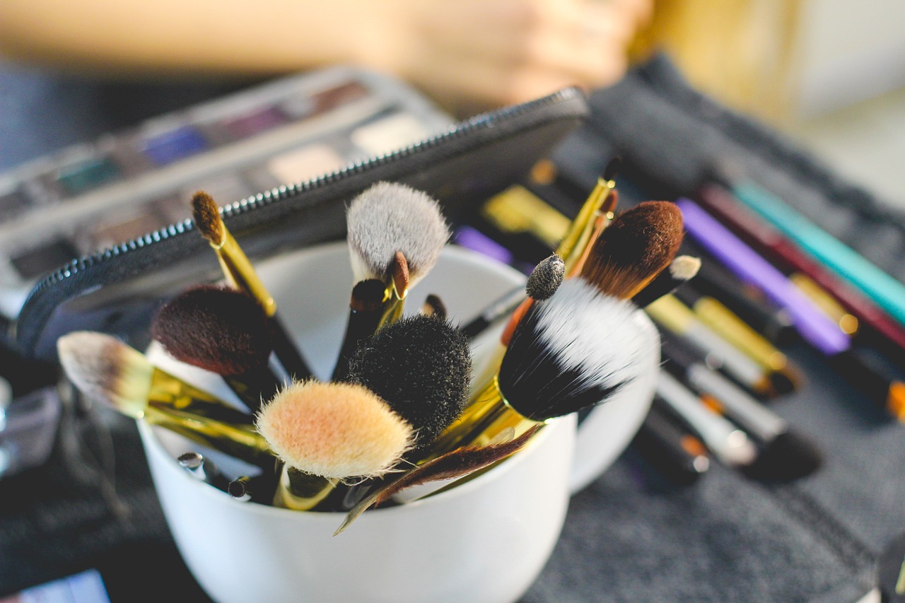 a cup filled with makeup brushes sitting on top of a table, by Robbie Trevino, shutterstock, process art, focus on face and facial details, soft morning light, yellow makeup, stock photo