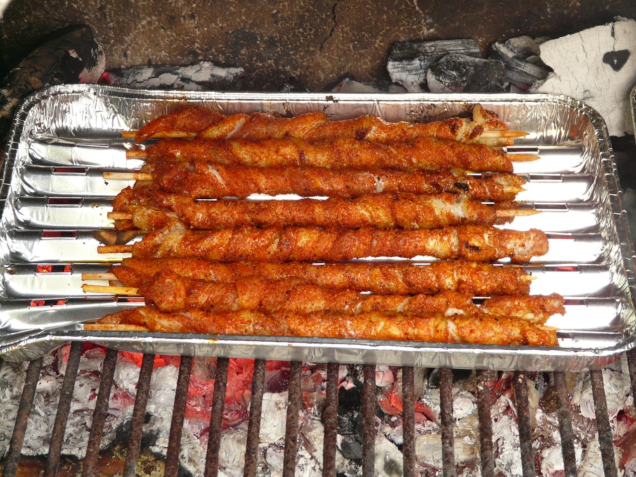 a close up of a tray of food on a grill, hurufiyya, long metal spikes, absolutely outstanding image, stacked, recipe