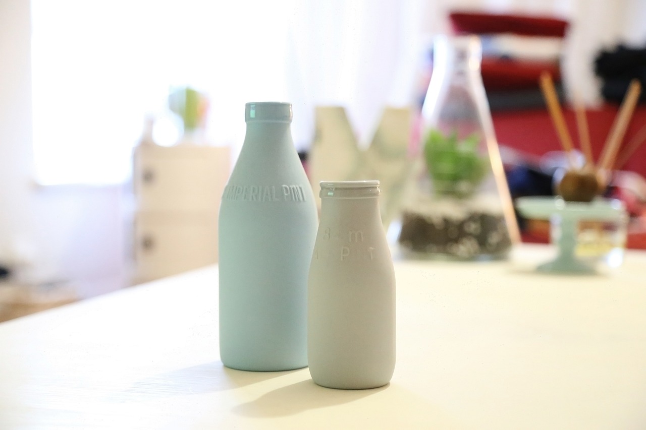 a couple of bottles sitting on top of a table, by Anita Malfatti, minimalism, top milk brands, silicone cover, myminifactory, cold color