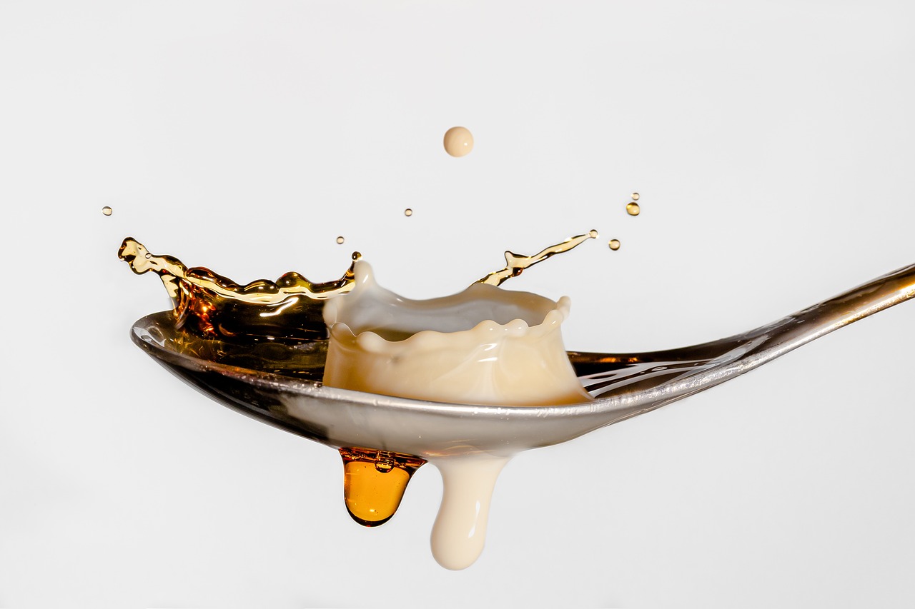 a spoon that has some liquid on it, a digital rendering, by Etienne Delessert, unsplash, renaissance, vanilla smoothie explosion, honey dripping, mario testino, mozzarella