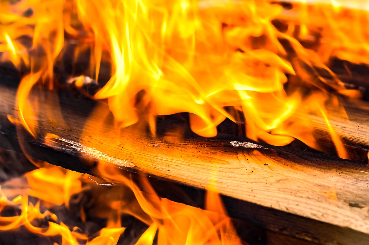 a pile of wood sitting on top of a fire, a picture, by Rodney Joseph Burn, shutterstock, skatepark in flames, detailed zoom photo, hd wallpaper, the matrix servers on fire