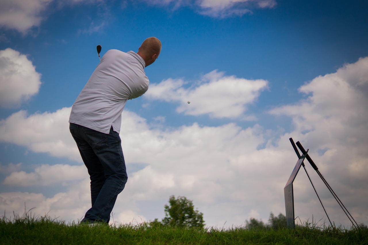 a man standing on top of a lush green field, a picture, by Jan Rustem, shutterstock, figuration libre, mid action swing, tournament, modern high sharpness photo, bald