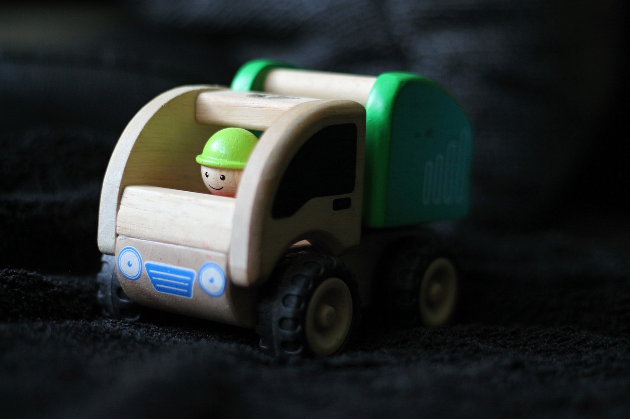 a close up of a toy truck on a black surface, a picture, by Sam Havadtoy, mingei, eco, cute boys, green head, a wooden