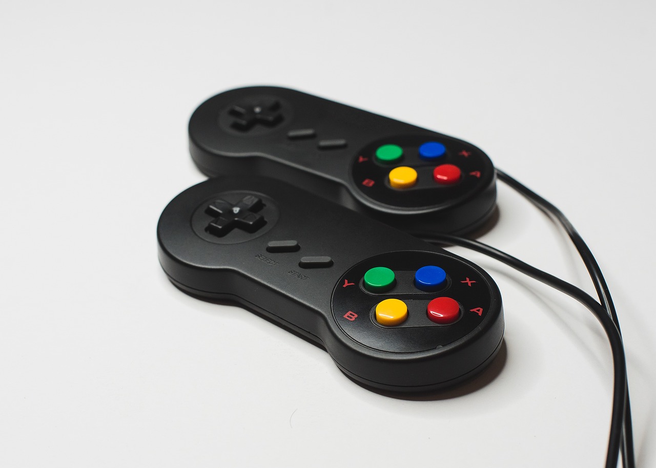 a couple of video game controllers sitting on top of a table, by Tadashi Nakayama, neogeo, closeup photo, productphoto, portlet photo, on grey background