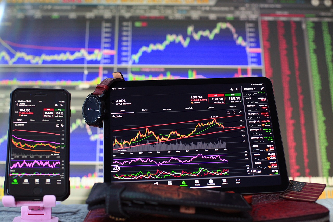 a laptop computer sitting on top of a desk next to a cell phone, a picture, analytical art, trading stocks, 4 k ], screens, traders