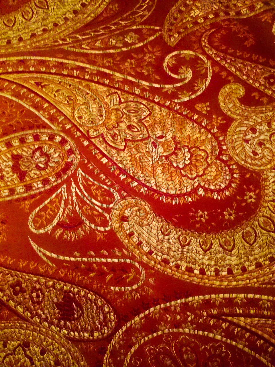 a close up of a red and gold paisley pattern, by Virginia Lee Burton, exquisite detail huge details, phone photo, linen, very detailed photo