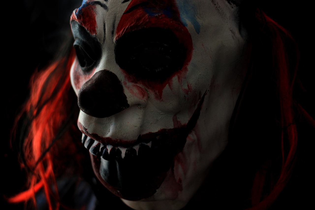 a close up of a person wearing a clown mask, reddit, digital art, big budget horror movie scene, photo taken with canon 5d, carnage fangs, very scary photo