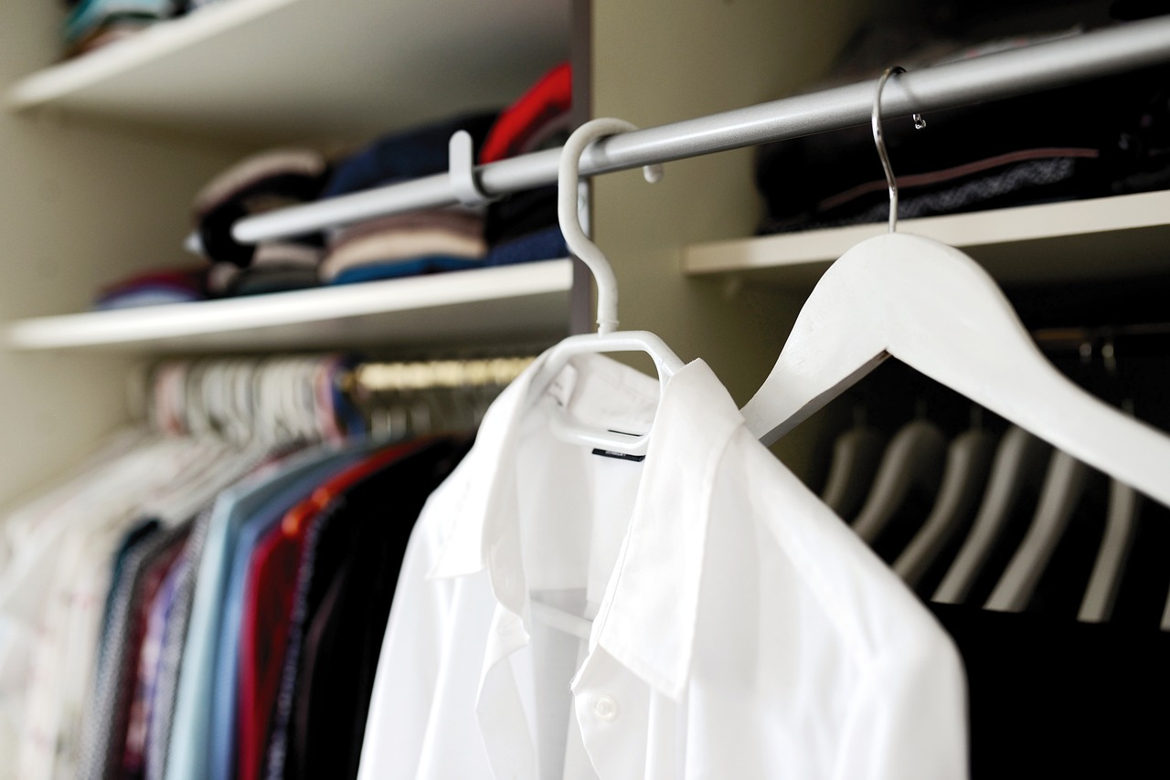 a white shirt hanging on a hanger in a closet, bauhaus, working clothes, compressed jpeg, image, hires