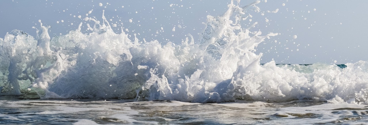 a man riding a wave on top of a surfboard, by Edward Corbett, pexels, fine art, wave of water particles, banner, white foam, background image