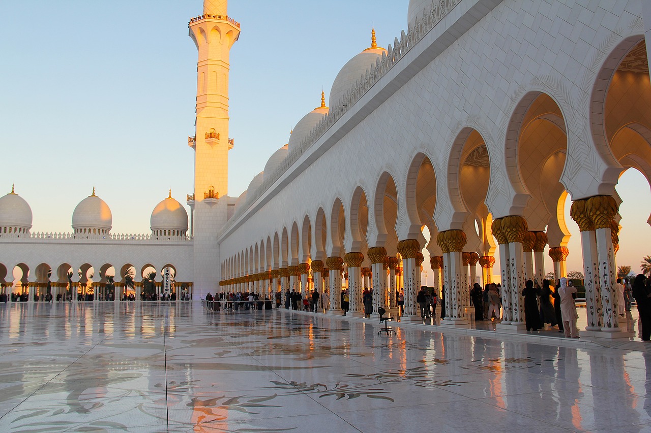 a group of people standing in front of a white building, a picture, by Sheikh Hamdullah, shutterstock, arabesque, shiny marble floor, morning golden hour, with large golden pipes, gulf
