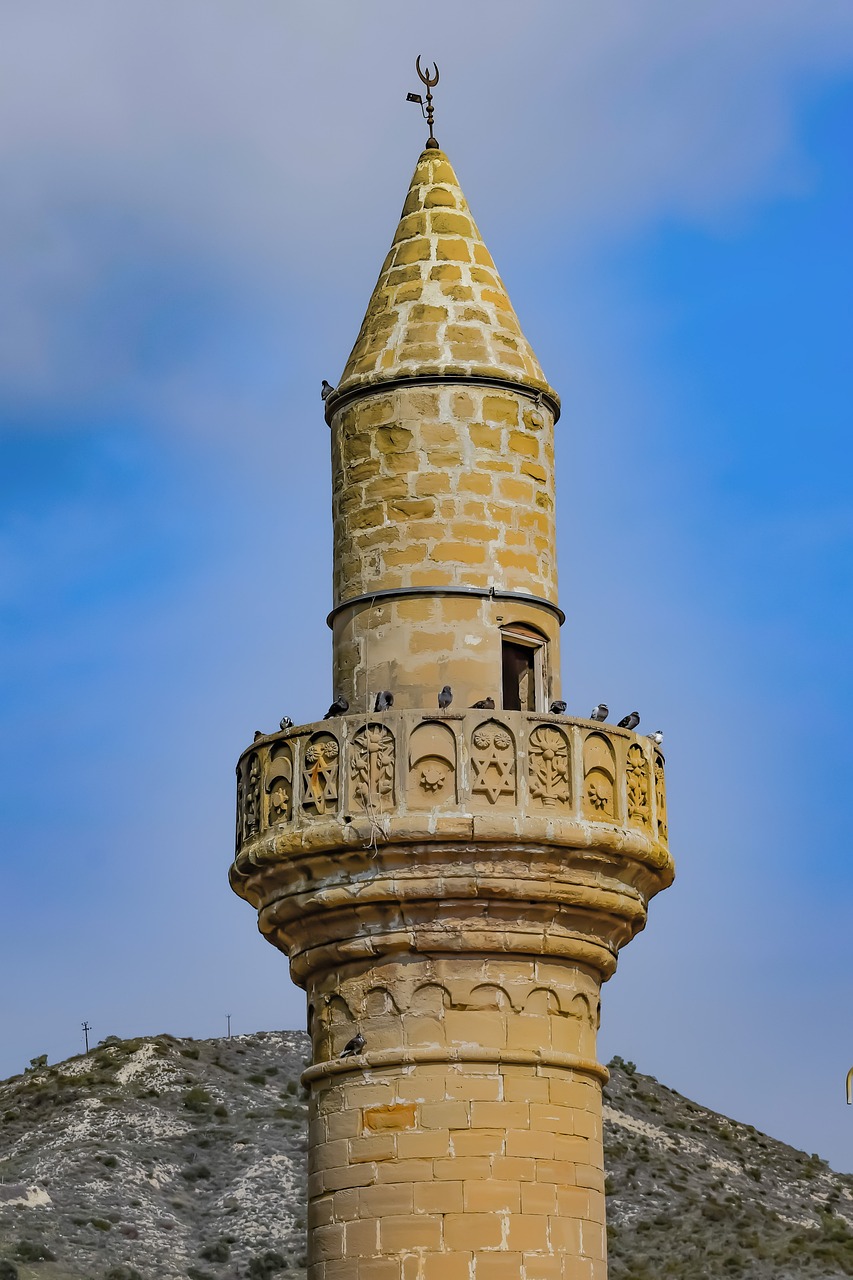 a tall tower with a clock on top of it, by Abdullah Gërguri, shutterstock, art nouveau, mardin old town castle, highly detailed photo 4k, ottoman miniature style, cone shaped