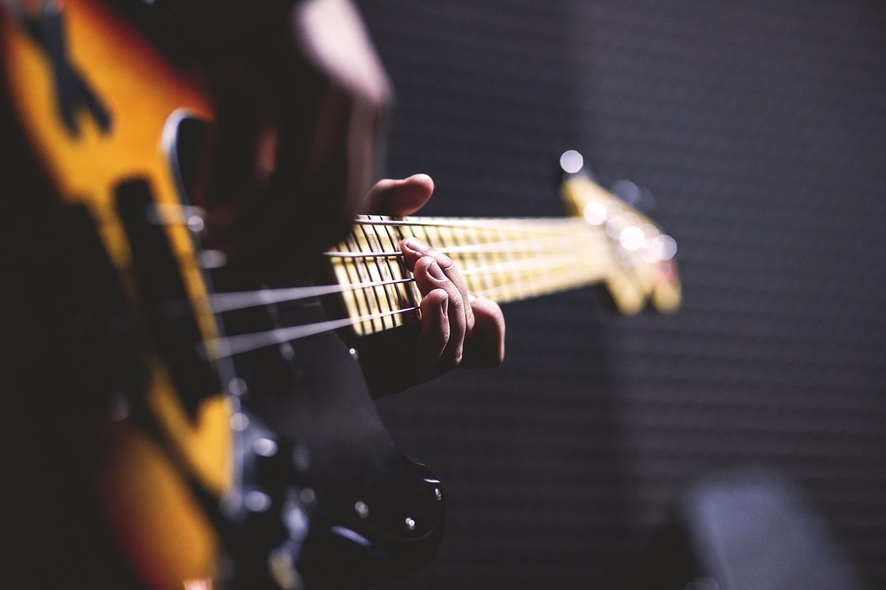 a close up of a person playing a guitar, by Niko Henrichon, bass music, avatar image, random content, half image