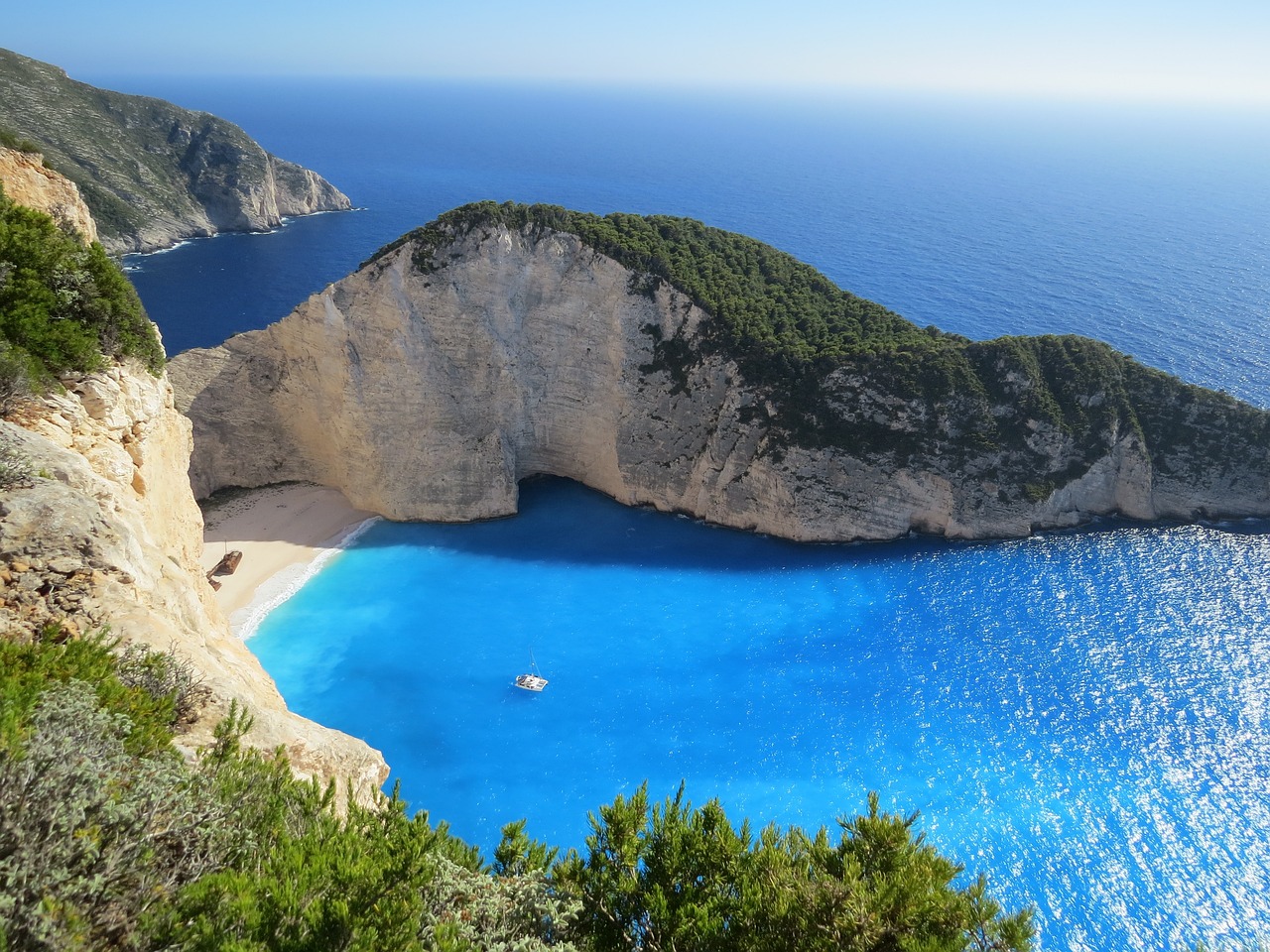 a large body of water next to a cliff, renaissance, greek ethnicity, blue sand, magical beach, onyx