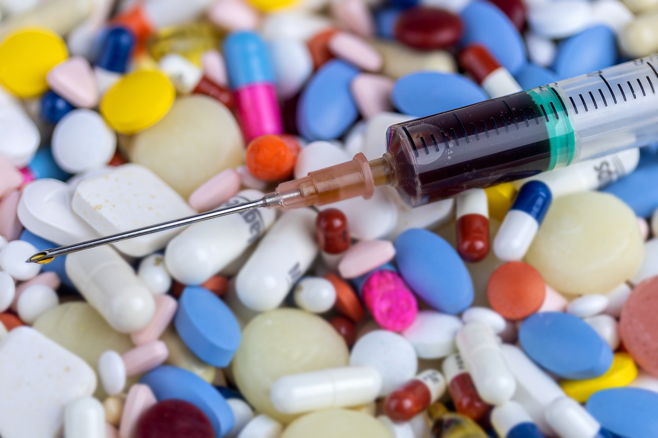 a syll sitting on top of a pile of pills, a picture, shutterstock, plasticien, syringe, detailed zoom photo, detailed product photo, embedded with gemstones