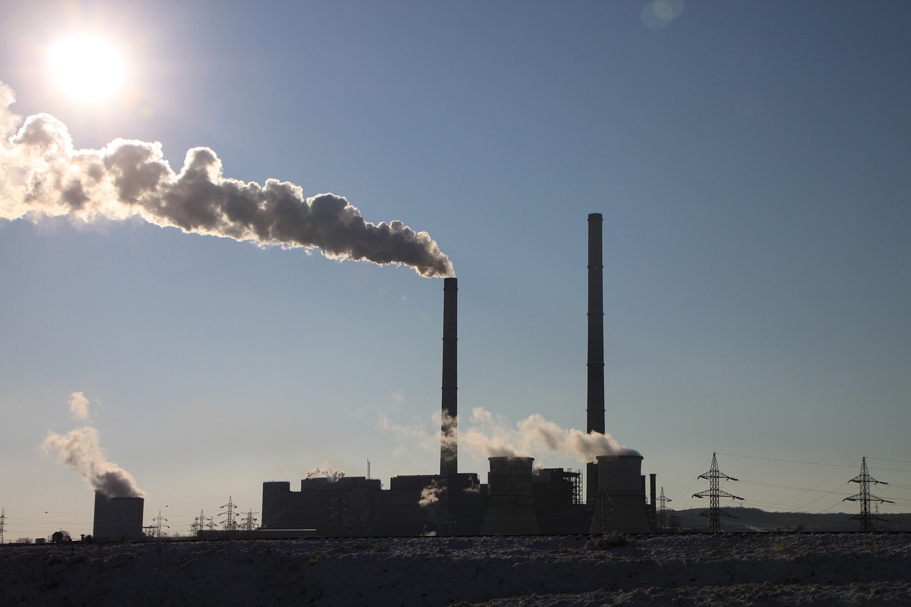 a factory with a lot of smoke coming out of it, a picture, shutterstock, purism, winter sun, stock footage