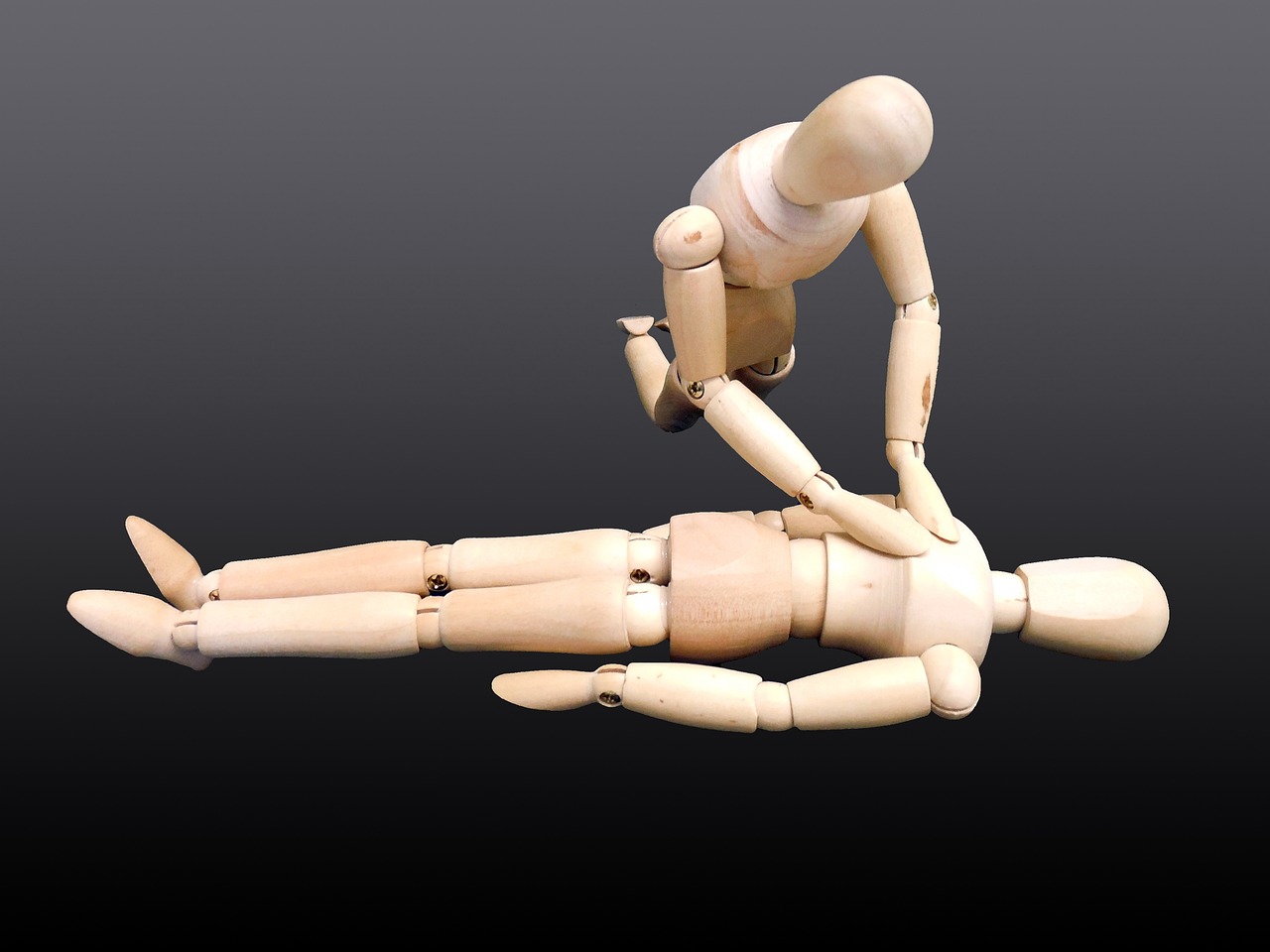 a wooden mannequin laying on top of another mannequin, pixabay, first aid kit, lying dynamic pose, long-arms, lerapi