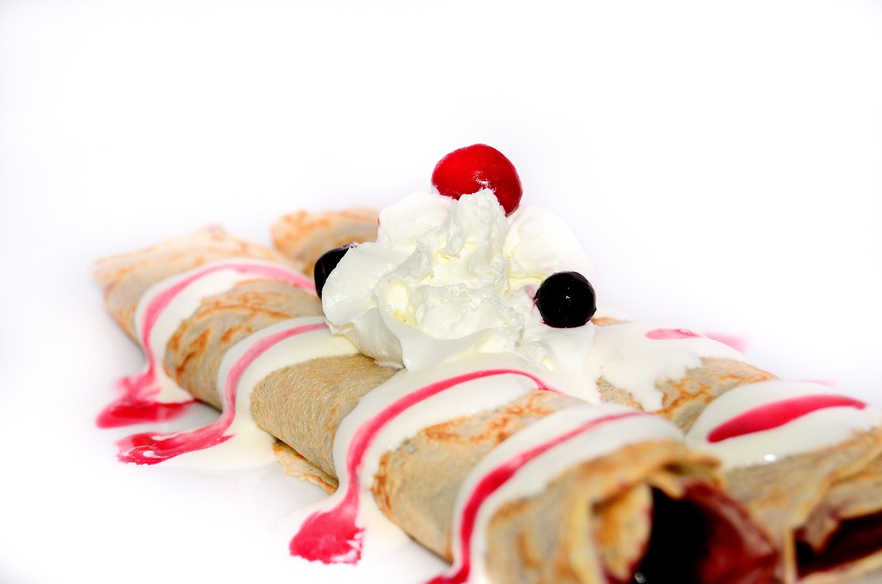 a white plate topped with a crepe covered in whipped cream and cherries, by Etienne Delessert, shutterstock, on a white background, cone, sauce, 1 2 0 mm