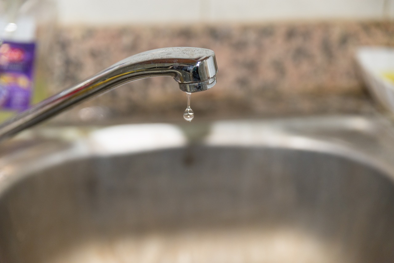 a kitchen sink with a faucet running from the faucet, a photo, sweat drops, tear drop, high res photo