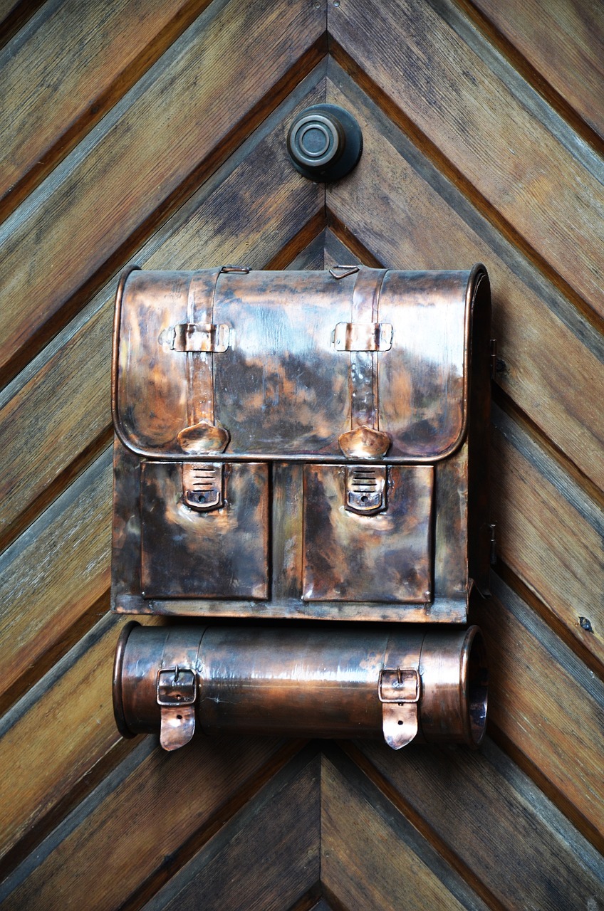 a brown leather briefcase hanging on a wooden wall, flickr, arts and crafts movement, reflections in copper, molten metal house, closeup photo, white metal