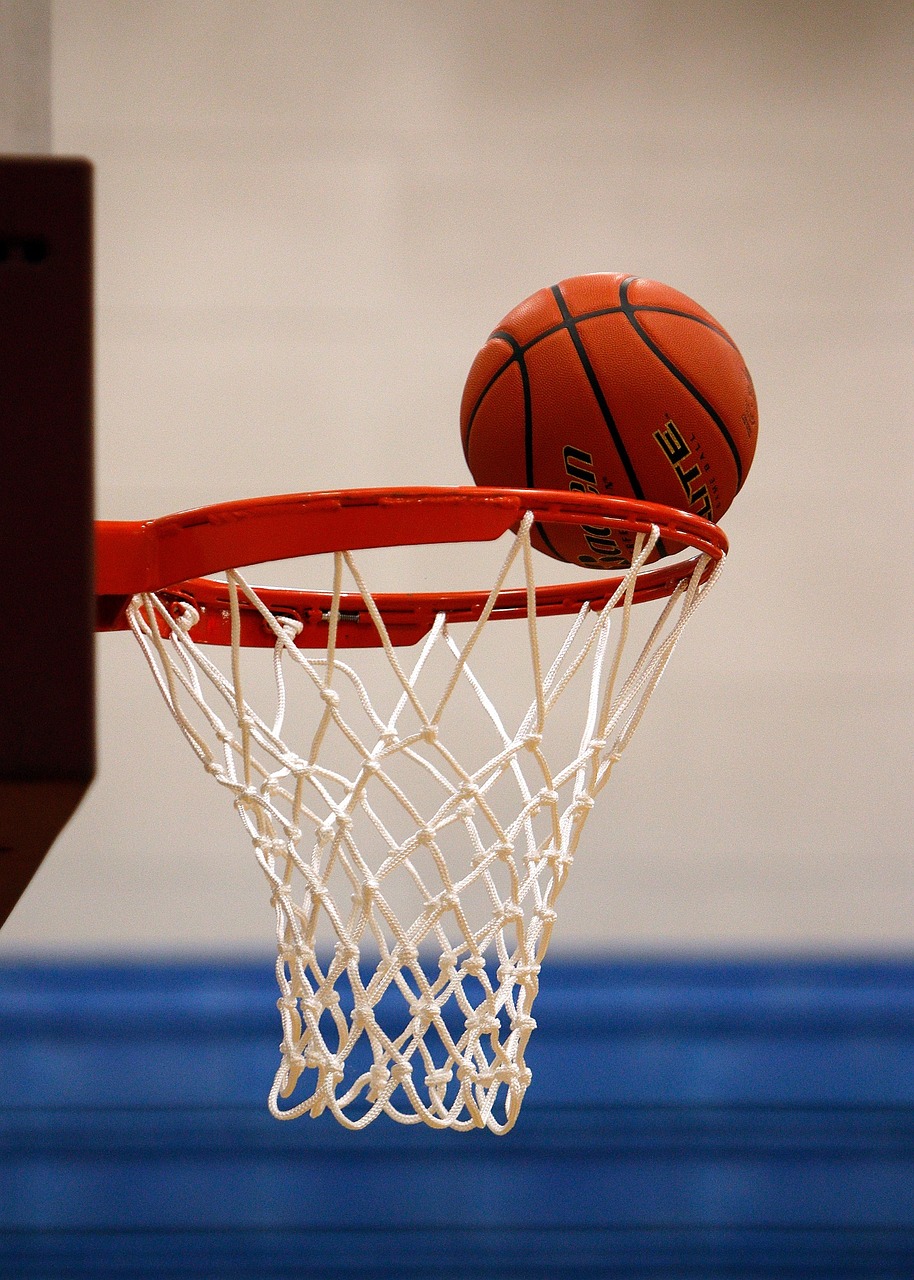 a basketball going through the rim of a basketball hoop, by David Burton-Richardson, dribble, istockphoto, nets, indoor, prizewinning