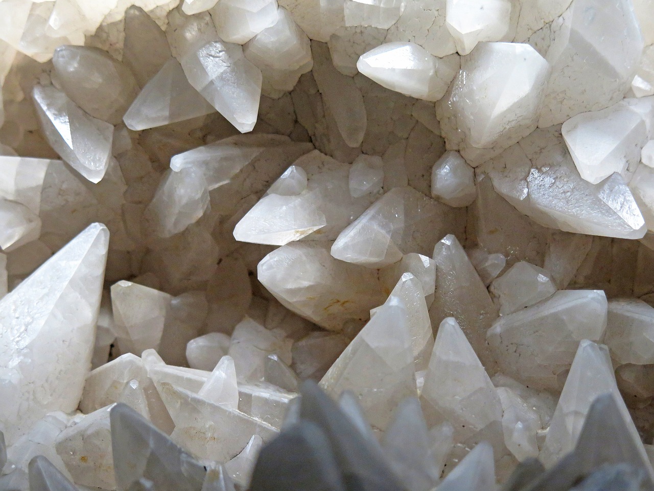 a pile of white crystals sitting on top of a table, by Whitney Sherman, in a beautiful crystal caverine, bottom body close up, whitehorns, version 3