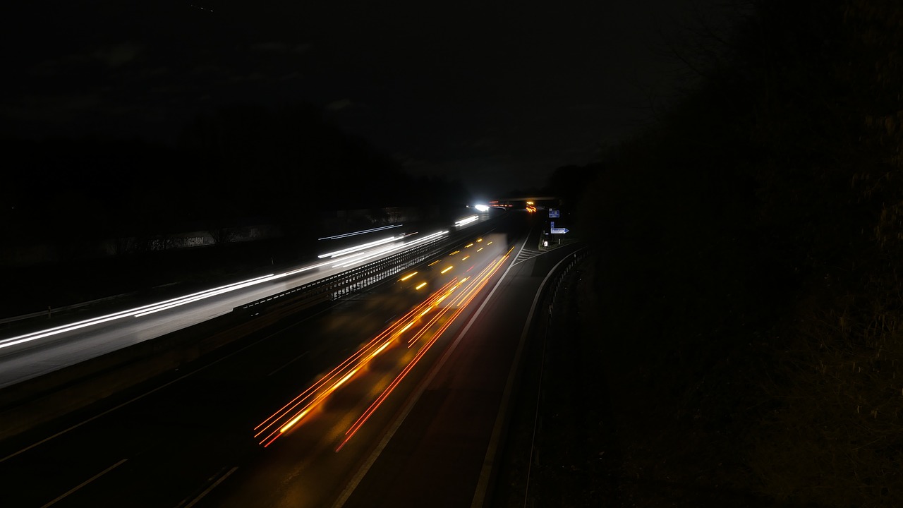 a train traveling down a train track at night, by Thomas Häfner, flickr, figuration libre, cars on the road, on a road, zoom photograph, 4k high res